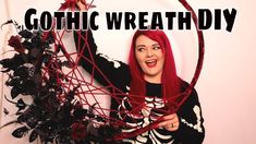 a woman with red hair is holding up a wire frame that says gothic wreath diy