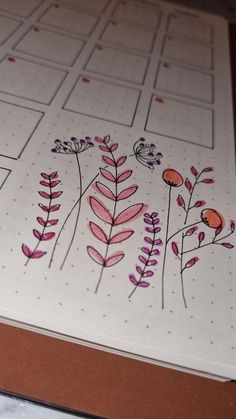 a paper with flowers and leaves drawn on it