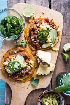 two tacos on a cutting board with green beans and jalapenos next to them