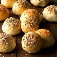 rolls with sesame seeds and poppy seed sprinkles on a wooden table top