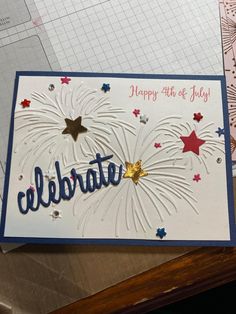 a happy fourth of july card with fireworks and stars in the sky, on top of a table