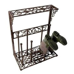 an iron rack with two pairs of shoes on it