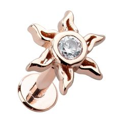 a gold plated ring with a crystal stone in the center and an open flower design