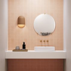 a bathroom with a sink, mirror and soap dispenser on the counter