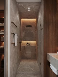 a walk in shower sitting inside of a bathroom next to a sink and towel dispenser