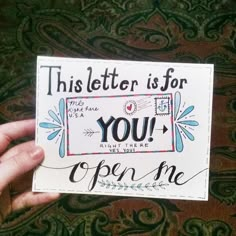 someone holding up a sign that says, this letter is for you open me