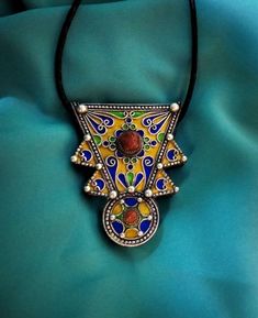 Ancient Berber talisman (herz) in sterling silver, enamelled in blue, green and yellow color. and decorated with a real coral cabochon. Height: 7 cm. Width: 5.5 cm. Leather: 54 cm. ++Material: sterling silver 925, real coral cabochon. ++Weight: 31.8 grams. ++ Origin: Morocco 1970s. Free worldwide shipping by DHL. I am always open to offers for one of my items, so please contact me if you would like to make an offer. Don't hesitate to contact me for any questions. All items advertised for sale ar Silver Jews, Solid Necklace, Berber Jewelry, Moroccan Jewelry, Ethnic Necklaces, Hand Of Fatima, African Jewelry, Amethyst Beads, Silver Pendants