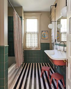 a bathroom with striped flooring and green walls