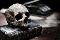 a skull sitting on top of an old book