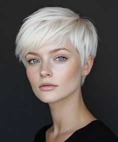 Add volume to your platinum blonde pixie with textured bangs for a more dramatic and glamorous look. The voluminous bangs create a bold and modern appearance, making this pixie cut perfect for those who want to stand out. Bright Platinum Blonde Hair, Voluminous Bangs, Hair Color Platinum, 4 Braids Hairstyle, Blonde Transformation, Platinum Blonde Pixie, Pixie Haircut Ideas, Textured Bangs, Platinum Blonde Hair Color