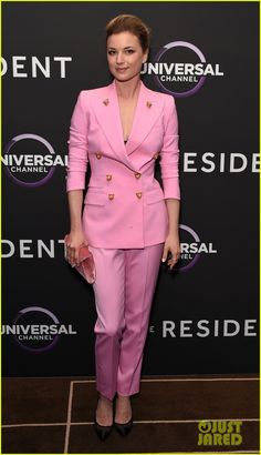 a woman in pink suit and heels at an event