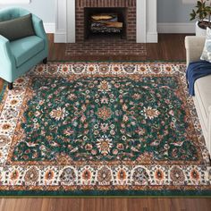 a living room filled with furniture and a rug on top of a hard wood floor