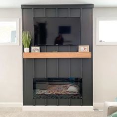 a living room with a fireplace and tv mounted on the wall above it's mantle