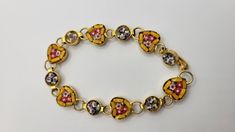 "This is a beautiful vintage 1960s micro mosaic bracelet. ATTRIBUTES  - Made in Italy - Tiny pieces of glass are used as tiles to create a beautiful pattern - Half of the links are shaped like hearts, the other half are round, and each link has tiny flowers in them - Set in goldtone - Some wear to the goldtone consistent with the age of the piece - Hook clasp MEASUREMENTS - The bracelet is about 6\" long, so it will only fit a *small wrist* such as a child or small adult unless you use an extend Vintage Heart Bracelet, Vintage Adjustable Heart Bracelets, Vintage Heart-shaped Bracelets For Gifts, Vintage Heart-shaped Bracelet With Charm, Vintage Charm Heart-shaped Yellow Gold Jewelry, 1960 Jewelry, Micro Mosaic, Tiny Flowers, Heart Bracelet