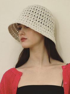 a woman wearing a white crochet hat