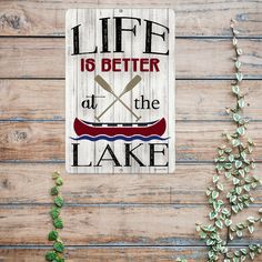 a wooden sign that says life is better at the lake