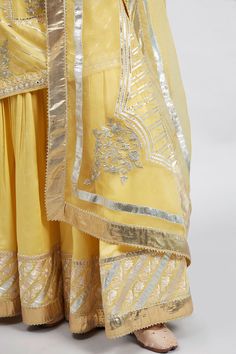 Daffodil yellow straight short kurta with ghunghro placket, gota trims and placement floral motifs. Comes with gharara and embroidered dupatta.
Component: 3
Embroidered
Neckline: Round
Sleeve Length: Three Quarter
Fabric: Kurta and Gharara: Chanderi Silk Banarasi; Dupatta: Silk Organza
Color: Yellow
Side slits
Striped pattern
Concealed placket - Aza Fashions Yellow Kurta, Daffodil Yellow, Short Kurta, Embroidered Dupatta, Embroidered Neckline, Silk Organza, Floral Motifs, Set For Women, Aza Fashion