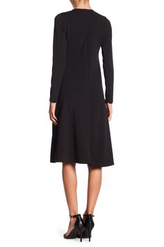 This long sleeve A-line dress is great for the office or dinner and makes for a classy, put-together look. Fit: this style runs small. 43" length (size Small) Crewneck
 Long sleeves A-line skirt 47% polyester, 47% rayon, 6% spandex Machine wash Made in the USA Model stats: 5'10", 32" bust, 25" waist, 36" hip. Model is wearing size Small. Winter A-line Midi Dress For Office, Black Long Sleeve Midi Dress For Work, Black A-line Long Sleeve Dress For Winter, Sleek Long Sleeve Midi Dress For Office, Black Long Sleeve Business Dress, Fall A-line Office Dresses, Fall Office A-line Dresses, Classic Long Sleeve Midi Dress For Business, Office A-line Midi Dress For Fall