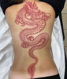 a woman with a dragon tattoo on her back