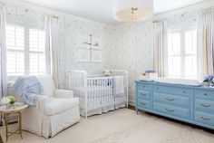 a baby's room with blue and white furniture