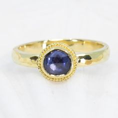 This beautiful 18K Treasure Gold ring, crafted with sunken treasure, showcases a majestic 0.83ct rose-cut blue sapphire. Enjoy the delightful shimmer of its water-ripple band, while its ancient feel adds a touch of mystery to any outfit. While I can make similar style rings, this one is one-of-a-kind owing to the irregular cut of the gem. Handcrafted in solid 18K gold made with 400 year-old sunken treasure recovered from the Caribbean. Size 7.25, but each ring comes with free sizing and FREE SHI Vintage 14k Gold Sapphire Ring With Rose Cut Diamonds, Round Sapphire Jewelry With Rose Cut Diamonds, Antique 14k Gold Sapphire Ring With Rose Cut Diamonds, Blue Cabochon Sapphire Ring In 14k Gold, Heirloom Sapphire Ring With Rose Cut Diamonds, Marquise Shape, Water Ripples, Blue Sapphire Rings, Rose Cut, Sapphire Ring