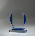 a blue and white glass award on a silver surface with a black base in the middle