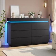 a black dresser with blue lights on it