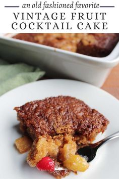 a close up of a piece of cake on a plate with a fork and bowl in the background