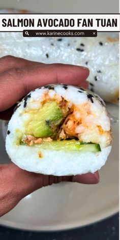 someone is holding up a sushi in their hand with the words salmon avocado fan