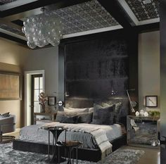 a bedroom with a large bed and black walls