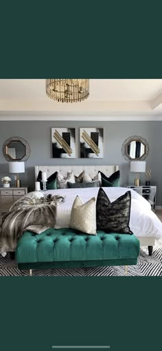 a bedroom with a bed, mirror and chandelier on the wall above it