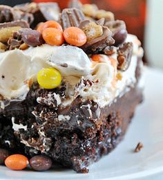 a close up of a piece of cake on a plate with candy beans and marshmallows