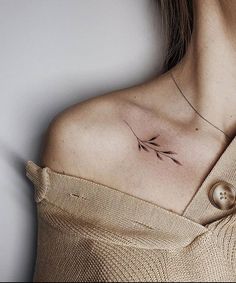 a woman with a small tattoo on her shoulder