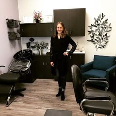 a woman standing in a room with several chairs