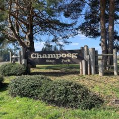 the entrance to chappog state park with trees and bushes in the foreground