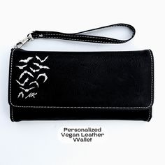 "This listing is for one Goth Wallet Bat Wallet Personalized Cute Wallet Vegan Leather Wristlet Wallet Goth Accessories Custom Gothic Gift Halloween Wristlet . PRODUCT DETAILS: ❧ Size: 7 1/2\" x 4\" ❧ Color: Black with Silver engraving (also available in purple faux leather with black engraving)  ❧ 12 card slots ❧ ID slot ❧ Zipper compartment for change ❧ Larger compartment for bills ❧ RFID protection ❧Detachable wrist strap and a snap closure  HOW TO ORDER: ❧ Please select your color (Black or Black Clutch Wristlet For Gift, Black Wristlet With Card Slots For Gift, Black Clutch Wallets As Gift, Goth Wallet, Cute Wallet, Goth Accessories, Gothic Gifts, Cute Wallets, Gothic Home Decor