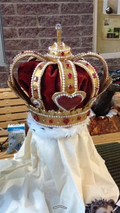 a crown sitting on top of a table next to a stuffed animal