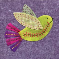 an embroidered bird is sitting on a purple background