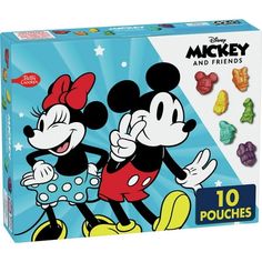 the mickey and minnie mouse puzzle is in its box with various candies on it