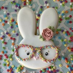 a cookie decorated like a bunny with glasses on it's face and beads around its eyes