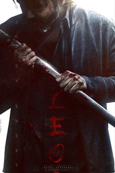 a man holding a baseball bat on top of a poster