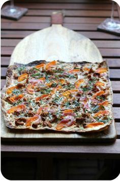 a pizza sitting on top of a wooden cutting board