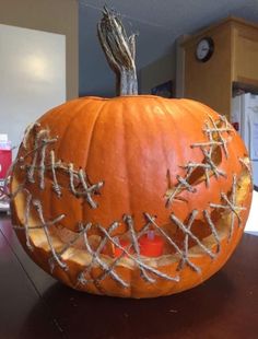 a carved pumpkin with barbed wire on it