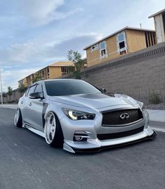 a silver car is parked on the street