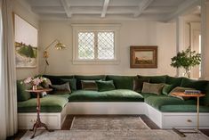 a living room with green couches and rugs