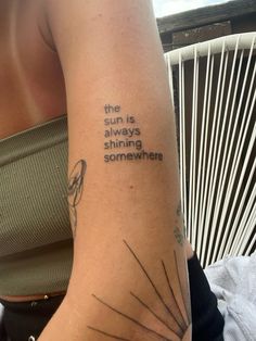 a woman with a tattoo on her arm saying the sun is always shining somewhere