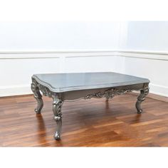 an antique style coffee table on hardwood flooring