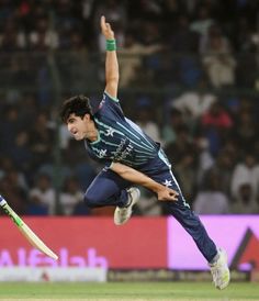 a man is jumping in the air to catch a ball with his leg and arm