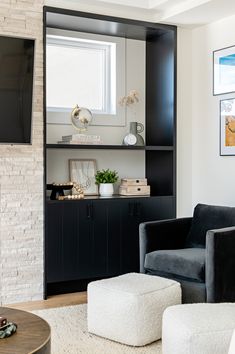 a living room with black and white furniture