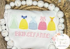 three princess dresses on a white t - shirt surrounded by eggs